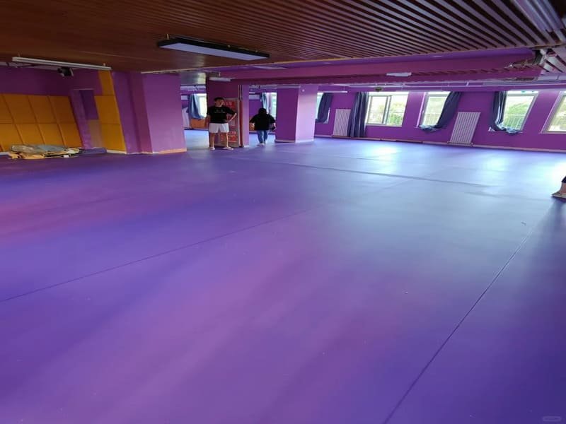 technician reviewing commercial vinyl flooring maintenance guide